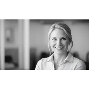 Smiling businesswoman providing a positive testimonial for IAE Consulting’s AI automation services, highlighting improved workflow efficiency.